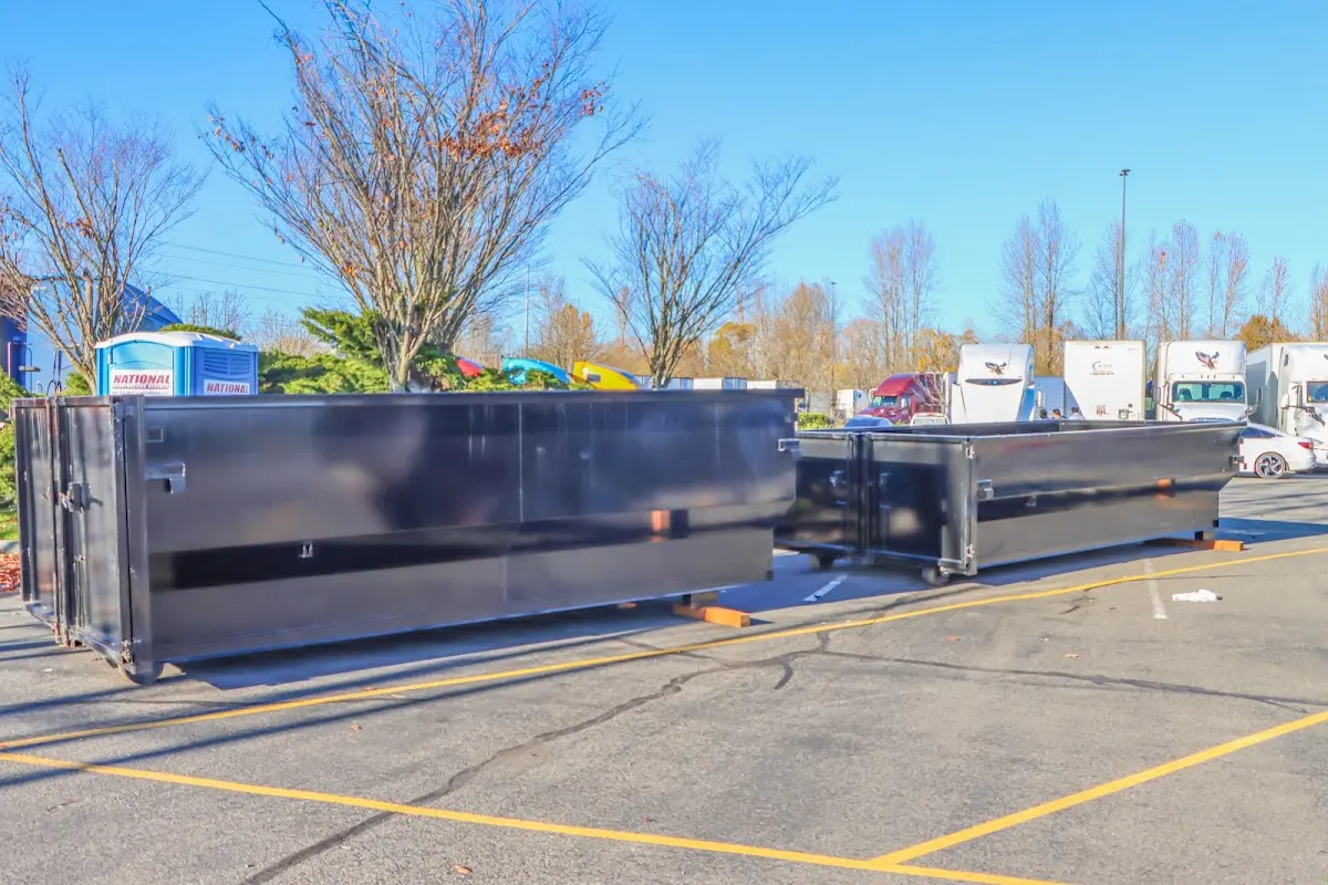 Professional dumpster rental service with roll-off container on residential driveway in Mokena